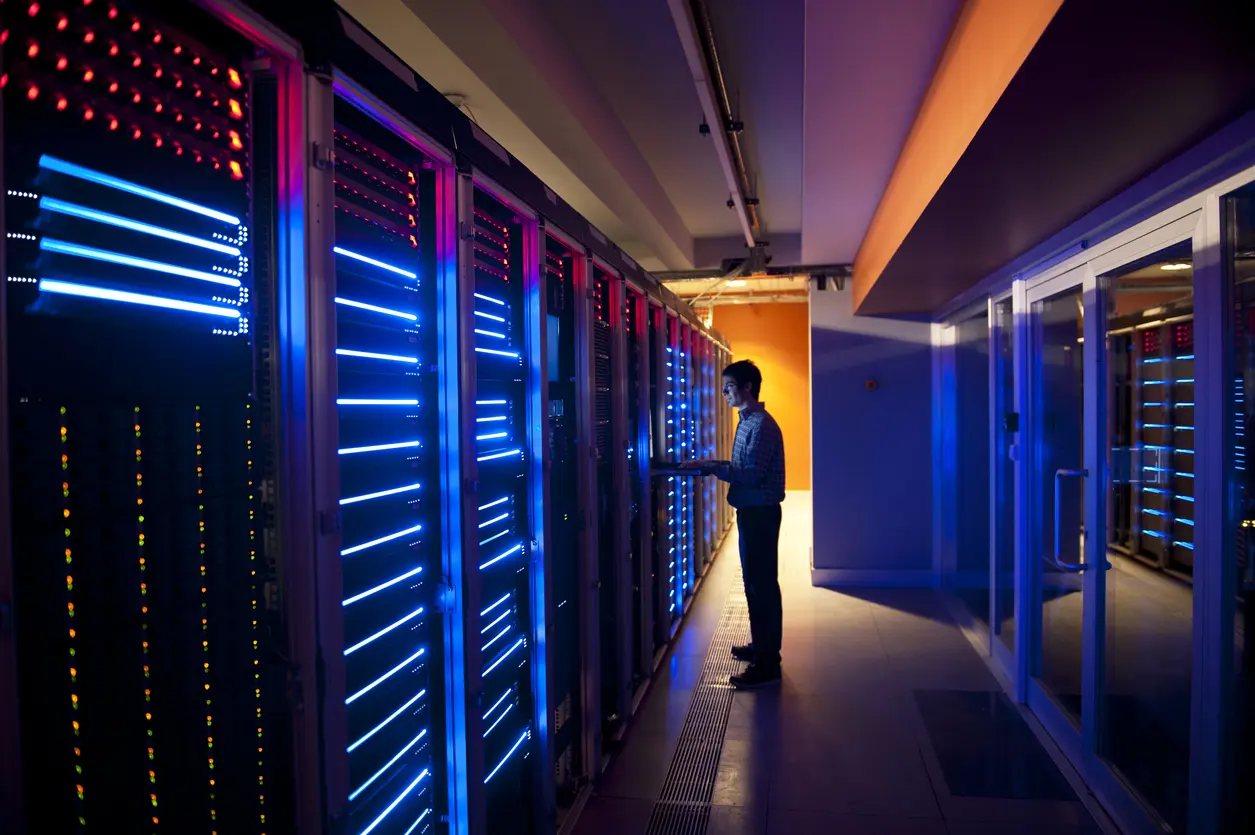 IT Engineer in Action Configuring Servers Modern interior of server room in datacenter. IT Engineer in Action Configuring Servers