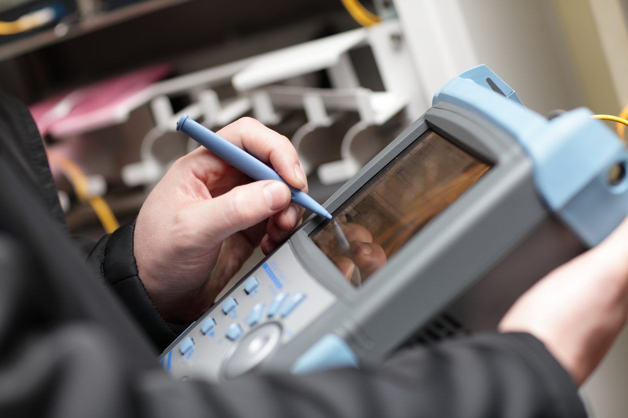 Reflectometer A technician working with reflectometer at the server room